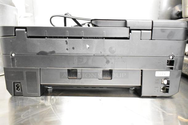 Canon K10546 Multifunction Printer, black, showing rear panel. Ports and cable visible. Condition appears used with some marks.