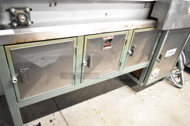 Lenin gas-powered chip fryer with 220,000 BTU, conveyor system, on commercial casters. Includes control panel and storage cabinets.