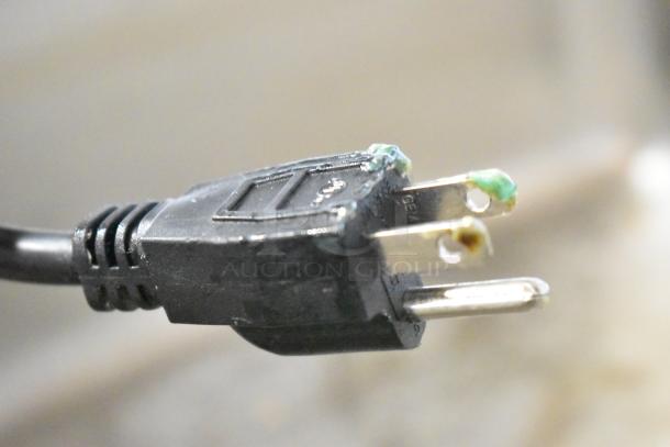 Power plug of Adcraft FW-1200W Food Warmer, 120V, showing signs of wear and corrosion on prongs.