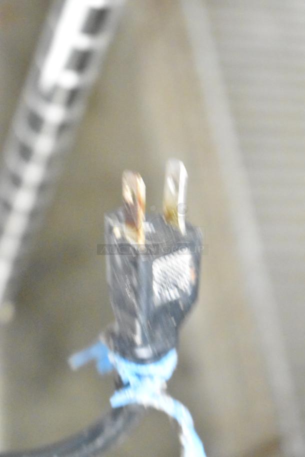 Blurry image of a power plug likely for the 2022 Avantco 178A19FHC Commercial Freezer, 115 Volts, 1 Phase.
