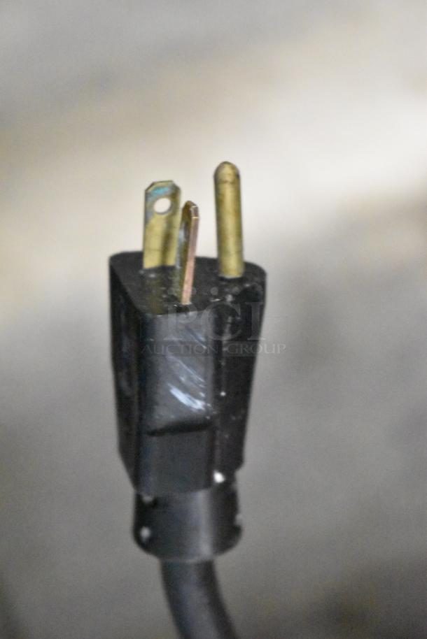 Close-up image of a three-prong electrical plug for Frosty Factory 232W commercial frozen cocktail machine.