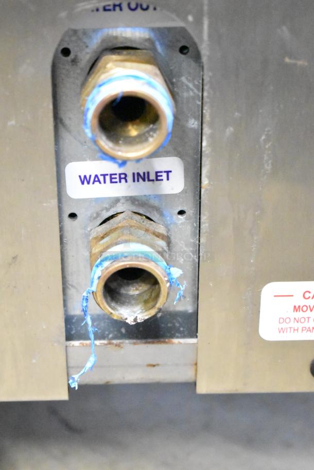 Frosty Factory 232W commercial frozen cocktail machine water inlet, showing plumbing connections with visible labels.
