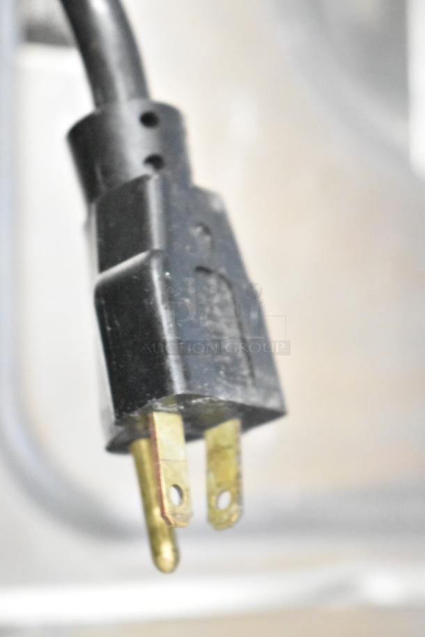 Close-up of a power plug from a Frosty Factory 232W Commercial Frozen Cocktail Machine, 208/230 Volts, 1 Phase.