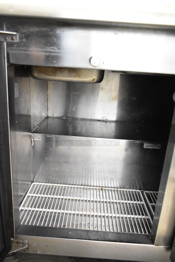 Cooltech CTR-48BMB prep table interior. Stainless steel, wire shelf, commercial-grade, shows minor wear.
