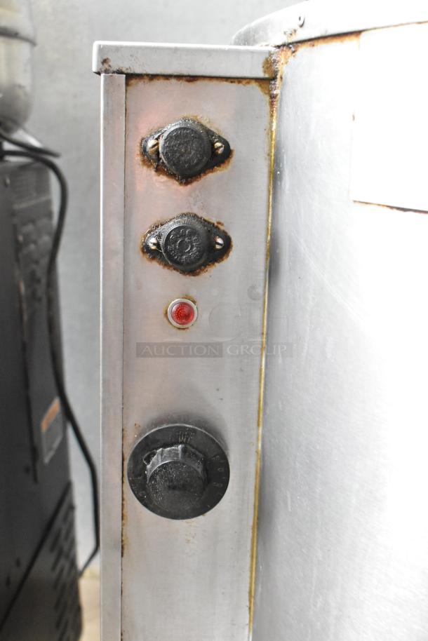 Groen EE-40 commercial 40-gallon steam kettle, showing control knobs and rust, indicating signs of use.