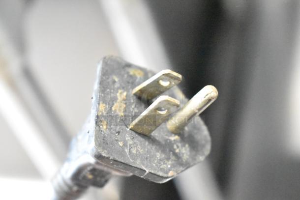 A close-up image of a worn electrical plug for a Glenray countertop soup kettle food warmer, 120 volts, 1 phase.