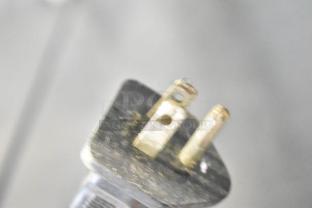 Close-up of a plug for a Glenray countertop soup kettle food warmer, 120 volts, showing two prongs and a grounding slot.