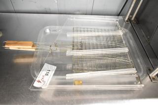 Seven assorted items including poly trays and wire racks, featuring wooden handles. Condition appears used. Label reads "716."