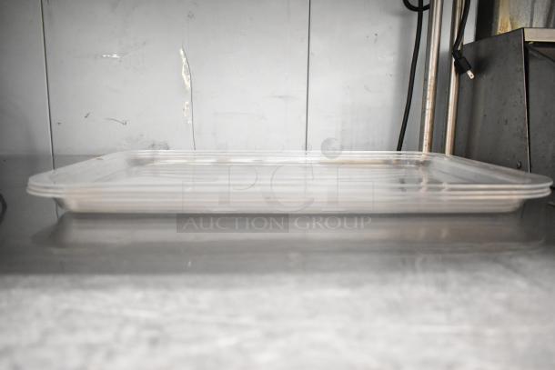 Clear rectangular poly tray, clean condition, part of a 7-piece auction lot. Durable material suitable for various uses.