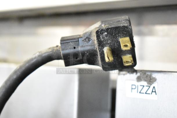 Black power plug for McCall 4-4045 Commercial 2-Door Reach-In Cooler, 115 volts, 1 phase. Tag reads "PIZZA". Dust visible.
