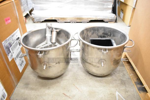 Two stainless steel mixing bowls and two paddle attachments for a Hobart mixer, showing minor wear, suitable for heavy-duty use.