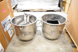 Two stainless steel mixing bowls and two paddle attachments for a Hobart mixer, showing minor wear, suitable for heavy-duty use.