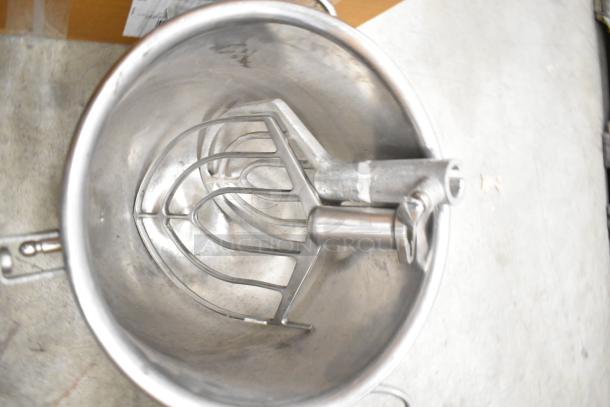 Hobart mixer accessories including metal mixing bowl and paddle attachment, stainless steel, used condition.