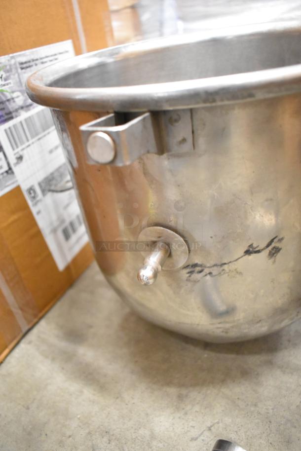 Stainless steel mixing bowl for Hobart mixer; visible scuffs and a mounting bracket, likely used, auction item.