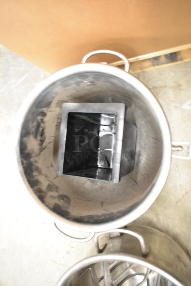 Stainless steel mixing bowls and paddle attachments for Hobart mixer; includes visible wear, ideal for commercial use.