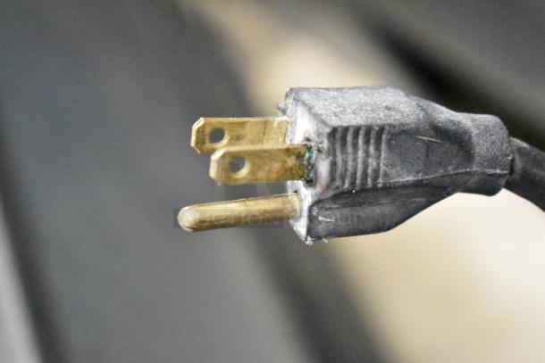 Close-up of the power plug for a Leader Commercial 2 Door Reach In Cooler Merchandiser, showing a three-prong design.