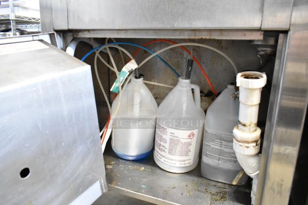 American Dish Service ADS ASQ undercounter glass washer, 120 volts, 1 phase. Interior showing connected cleaning solution bottles.