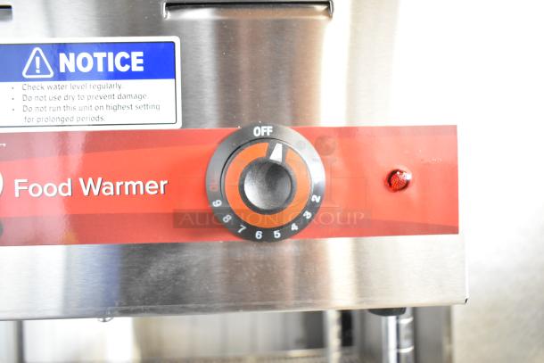 Brand new Avantco 177W43 4/3 size electric food warmer, 12"x27", 120V, with temperature dial and safety notice label.