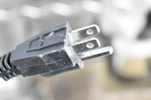 Power plug of a 2024 Carnival King 382WCM1 Waffle Cone Maker, 120V, 1 Phase, non-stick; slight scratch and dent condition.