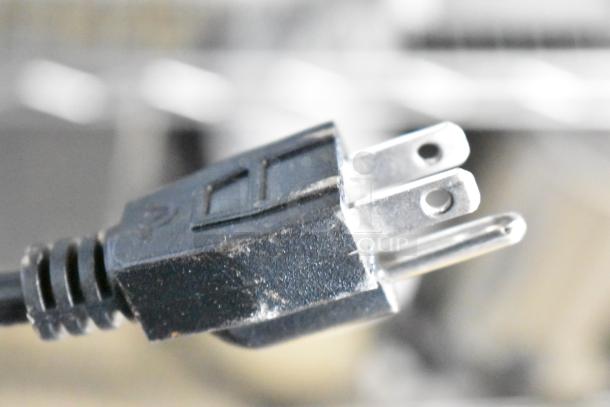 Power plug of the 2025 Carnival King 382CDPW2 Double Cone Dip Warmer, 120 Volts, showing minor scratches.