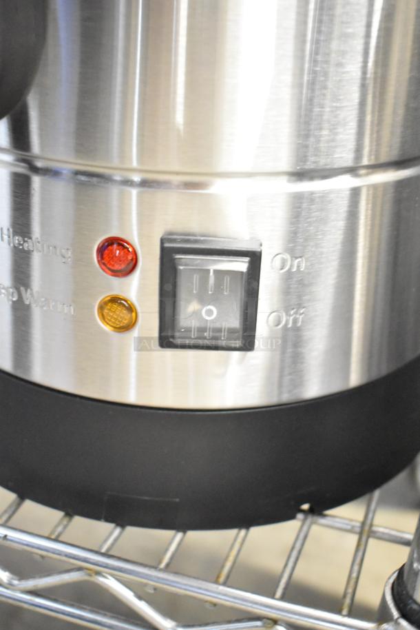 Close-up of Avantco WB8L stainless steel water boiler showing on/off switch and heating lights.
