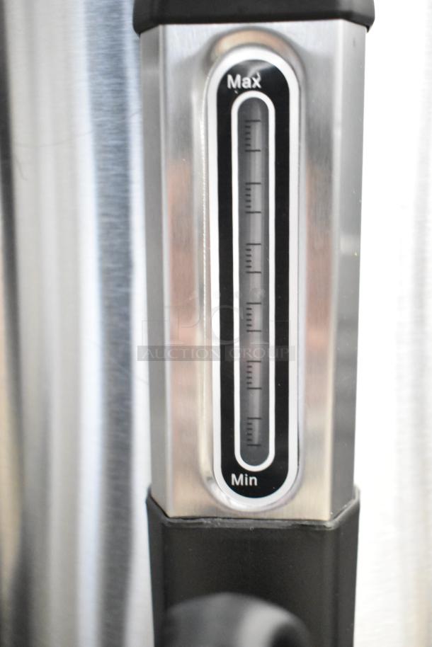 Water level gauge on a stainless steel appliance, labeled min to max.