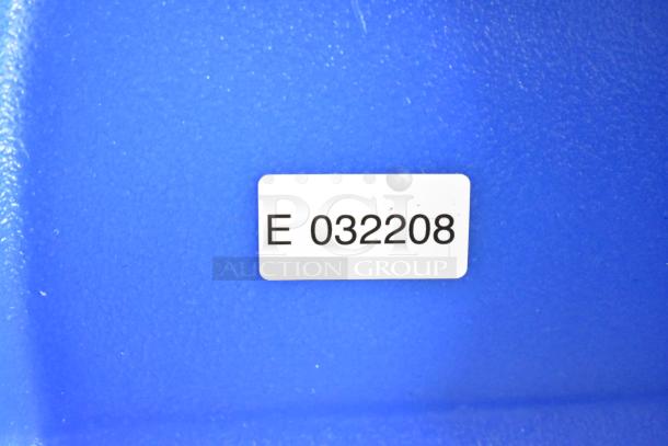 Label with code "E 032208" on a blue surface of the Lavex carpet extractor.