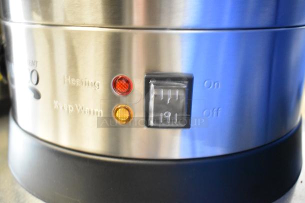 Close-up of a new Avantco stainless steel appliance control panel with heating and keep warm lights, on/off switch.