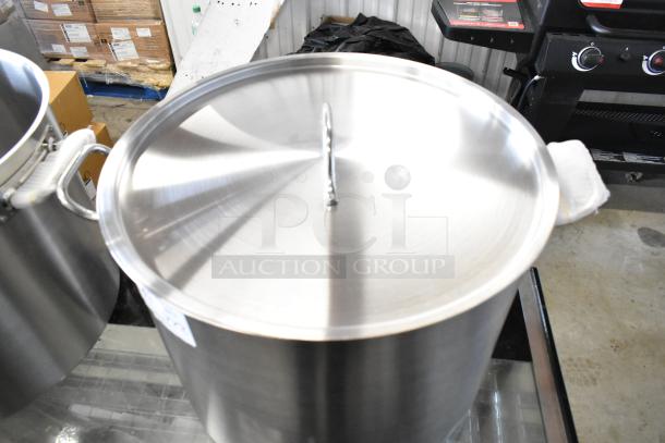 Stainless steel Vigor SS1 Series 60 Qt. stock pot with lid, new with minor scratches. Heavy-duty aluminum-clad design.