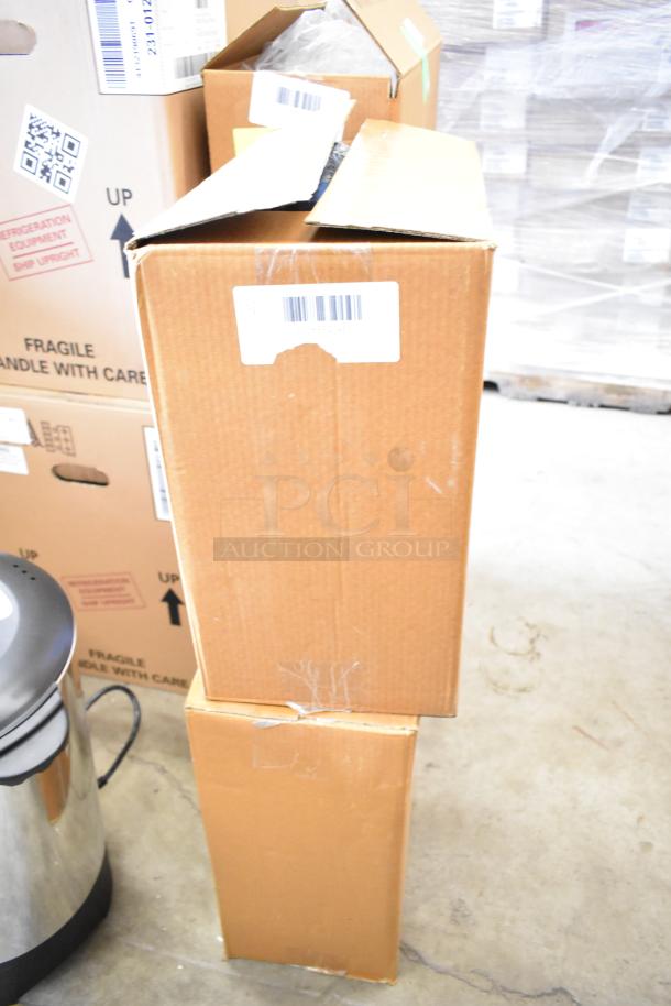 Two boxes containing new Regency powder-coated steel hose reels; one with a 50' x 1/4" hose, the other 30' x 1/4". Visible shipping labels and minor box wear.