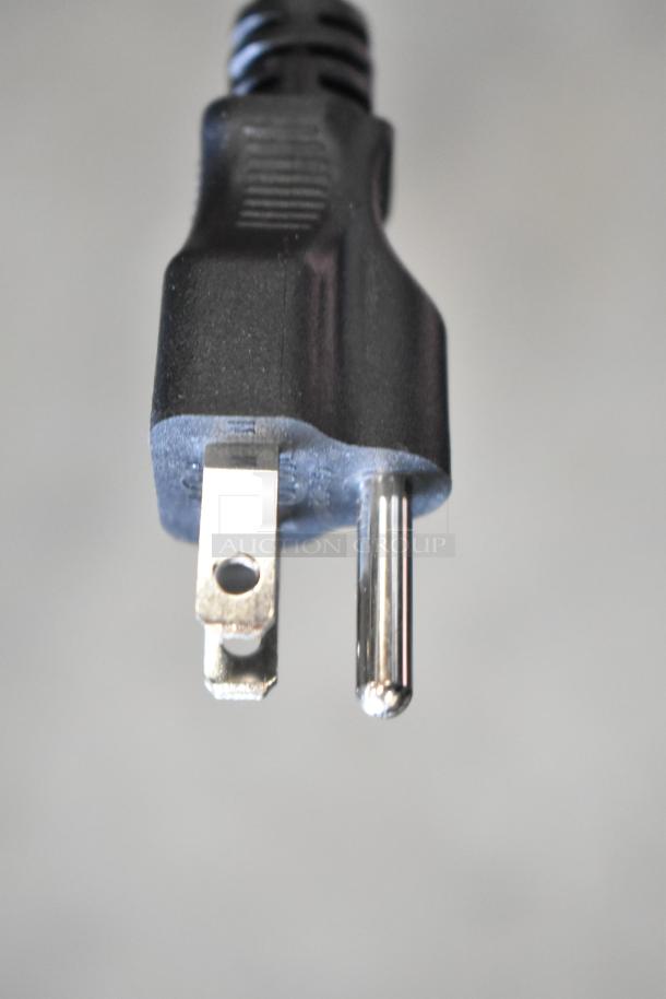 Close-up of a black three-prong plug against a neutral background.