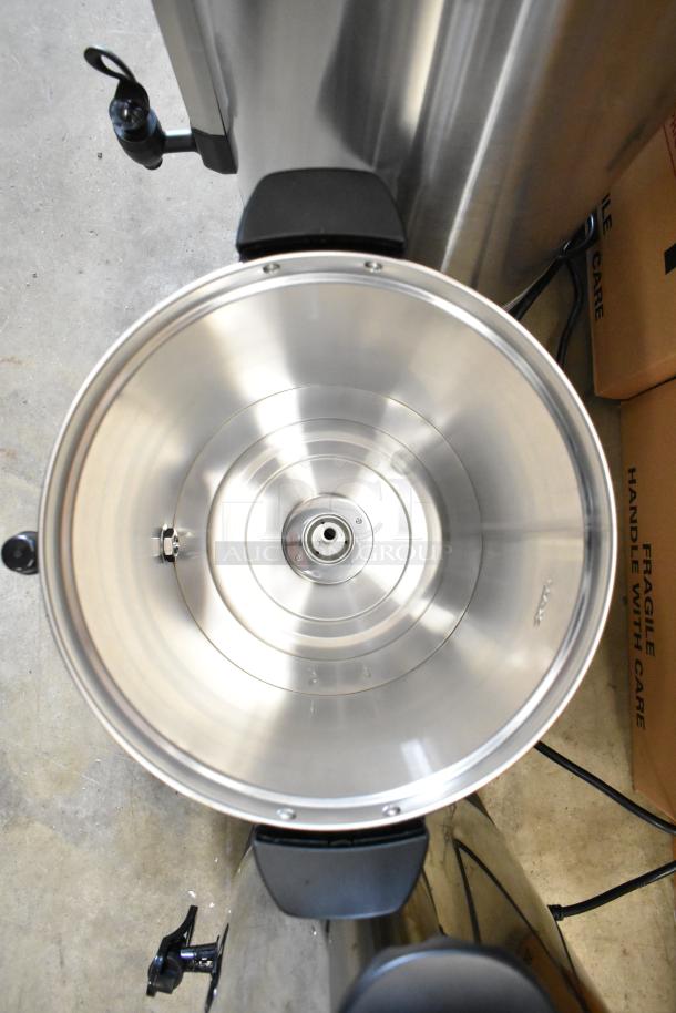 Stainless steel coffee urn interior, new condition, with visible spout and handle, part of auction lot.