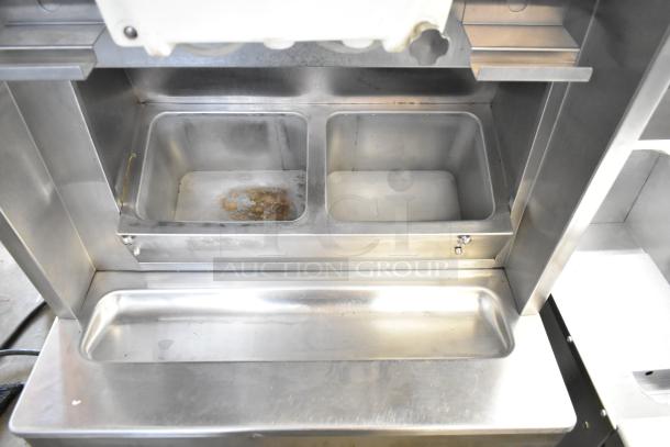 Taylor 8757-33 commercial soft serve ice cream machine interior; shows dual compartments, stainless steel construction.