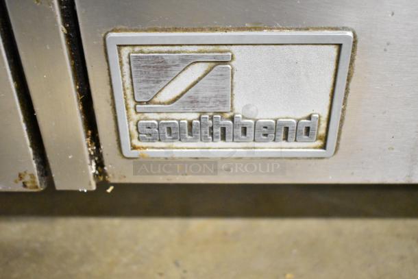 Southbend logo on a commercial gas range with 10 burners, 2 ovens, over shelf, and backsplash. Sturdy and reliable.