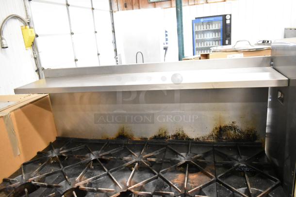 Southbend commercial gas 10 burner range with 2 ovens, over shelf, and backsplash. Signs of use. Ideal for professional kitchens.