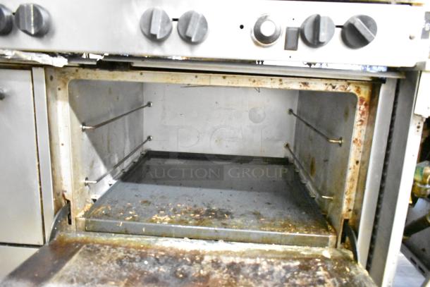 Southbend commercial gas range with 10 burners, 2 ovens, over shelf, and backsplash, showing interior condition.