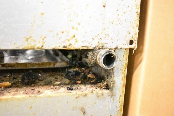 Southbend 10 Burner Range showing a close-up of a side component, with visible rust and debris.