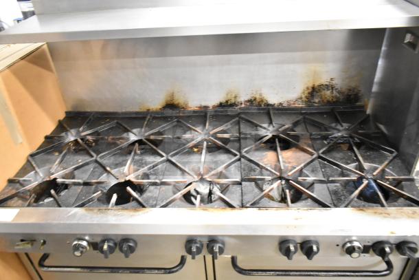 Southbend commercial gas-powered 10-burner range with 2 ovens, overshelf, and backsplash; visible wear and discoloration.