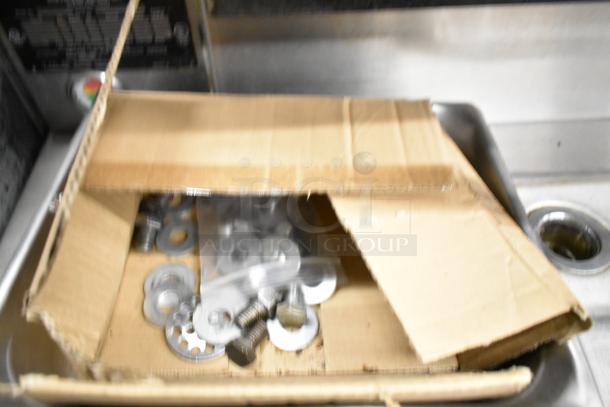 A Cleveland Commercial 2 Deck Pressure Steam Cabinet with metal components. Appears used, in a silver finish. Box with hardware visible.