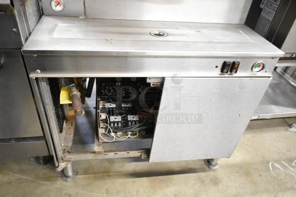Cleveland Commercial 2 Deck Pressure Steam Cabinet, stainless steel, open panel, gauges and controls visible, used condition.