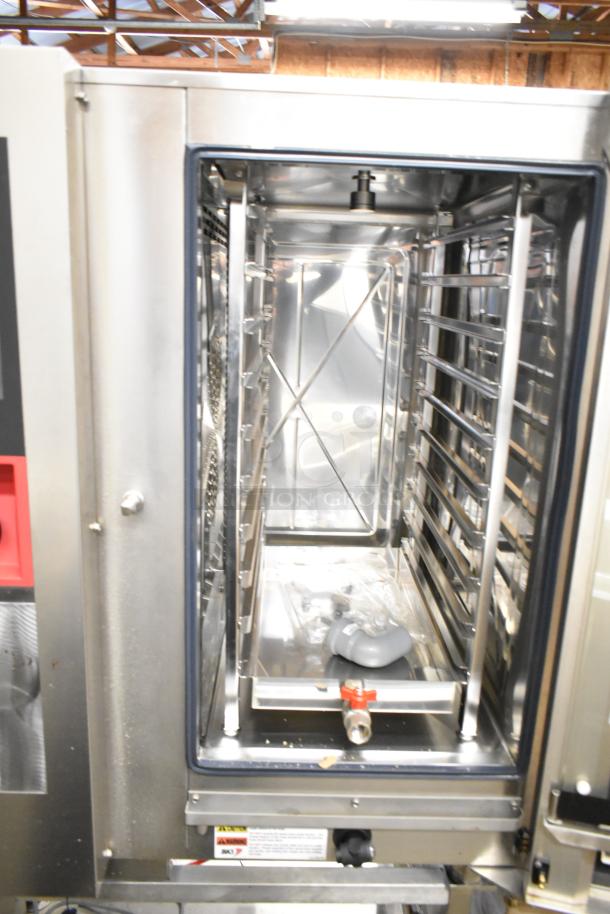 BKI AETG101R stainless steel natural gas combi convection oven, brand new with minor scratches and dents, on equipment stand.