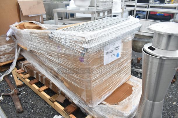 Four new scratch and dent items, including a cutting board and wire shelf, wrapped on a pallet. Label: MAR26-122.