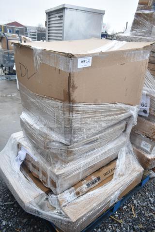 Pallet of 8 brand-new scratch and dent items wrapped in plastic, including a work table and floor mat. Box marked "DL".