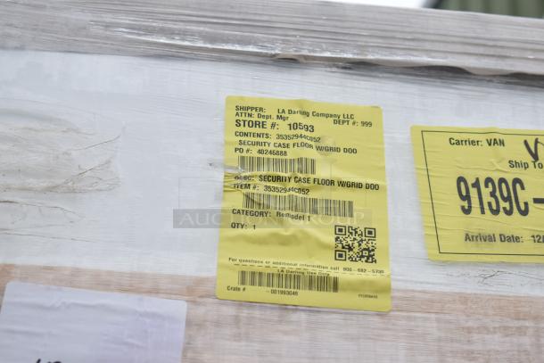 Brand new 35352944C052 security case floor w/ grid, scratch and dent, yellow shipping label detailing item info.