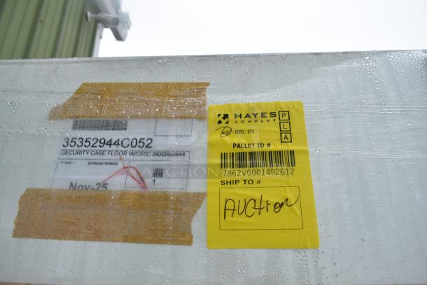 Brand new 35352944C052 security case floor with grid. Slight scratches and dents. Labels show item ID and pallet info.