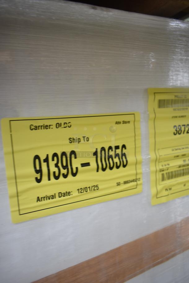 Brand new scratch and dent 35352944C052 security case floor with grid. Yellow shipping label visible with arrival date.