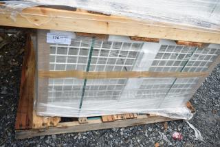 Brand new security case floor with grid, model 35352944C052, wrapped on wooden pallet, minor scratches visible.