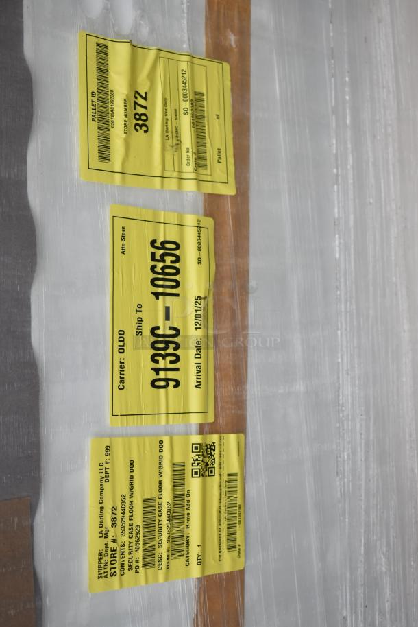 Brand new scratch and dent 35352944C052 security case floor with grid, packaged with yellow shipping labels.