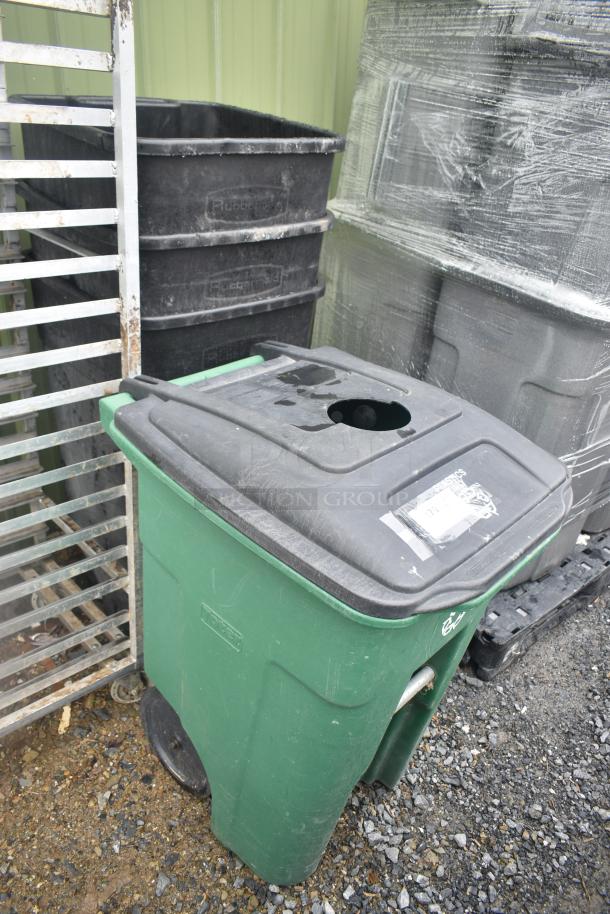 Four trash cans, including three black Rubbermaid and one green Poly trash can, grouped for auction bidding.