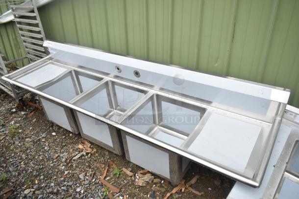 Brand new Regency 600S31818218 commercial sink, 94" 16-gauge stainless steel, three compartments, cross bracing, 2 drainboards, no legs.
